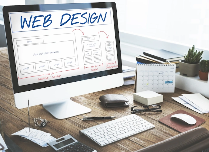 Photo of a computer screen showing a draft of a website design scheme